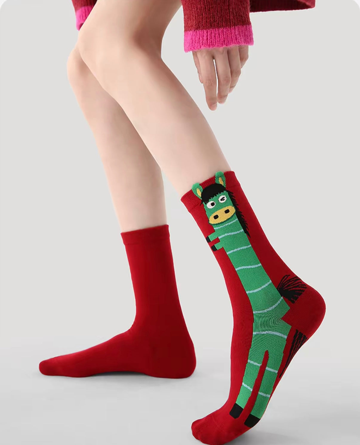 Year of Horse socks pack featuring three red socks with playful horse designs in purple, green, and pink