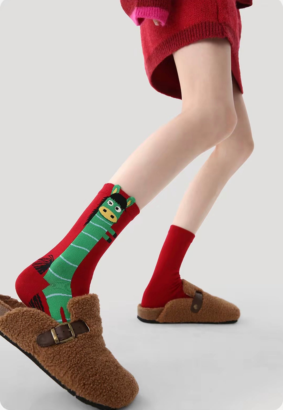 Year of Horse socks pack featuring three red socks with playful horse designs in purple, green, and pink