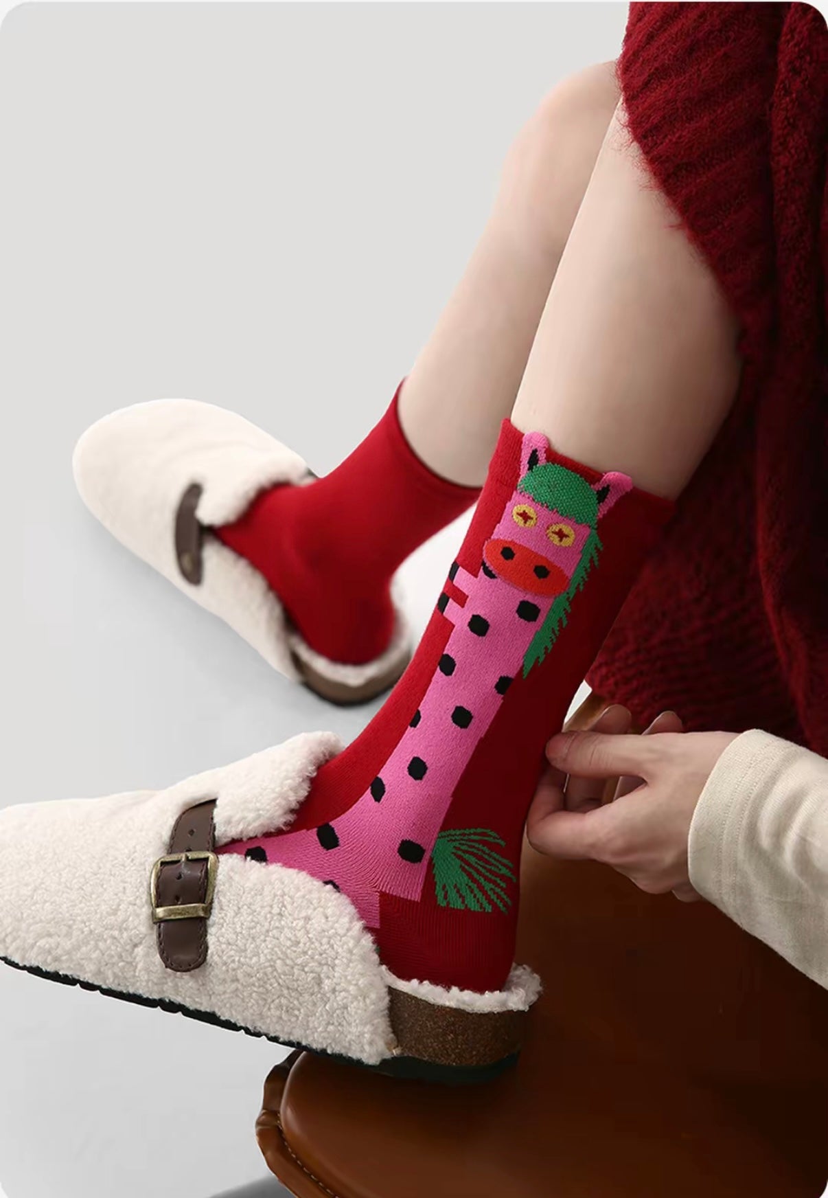 Year of Horse socks pack featuring three red socks with playful horse designs in purple, green, and pink