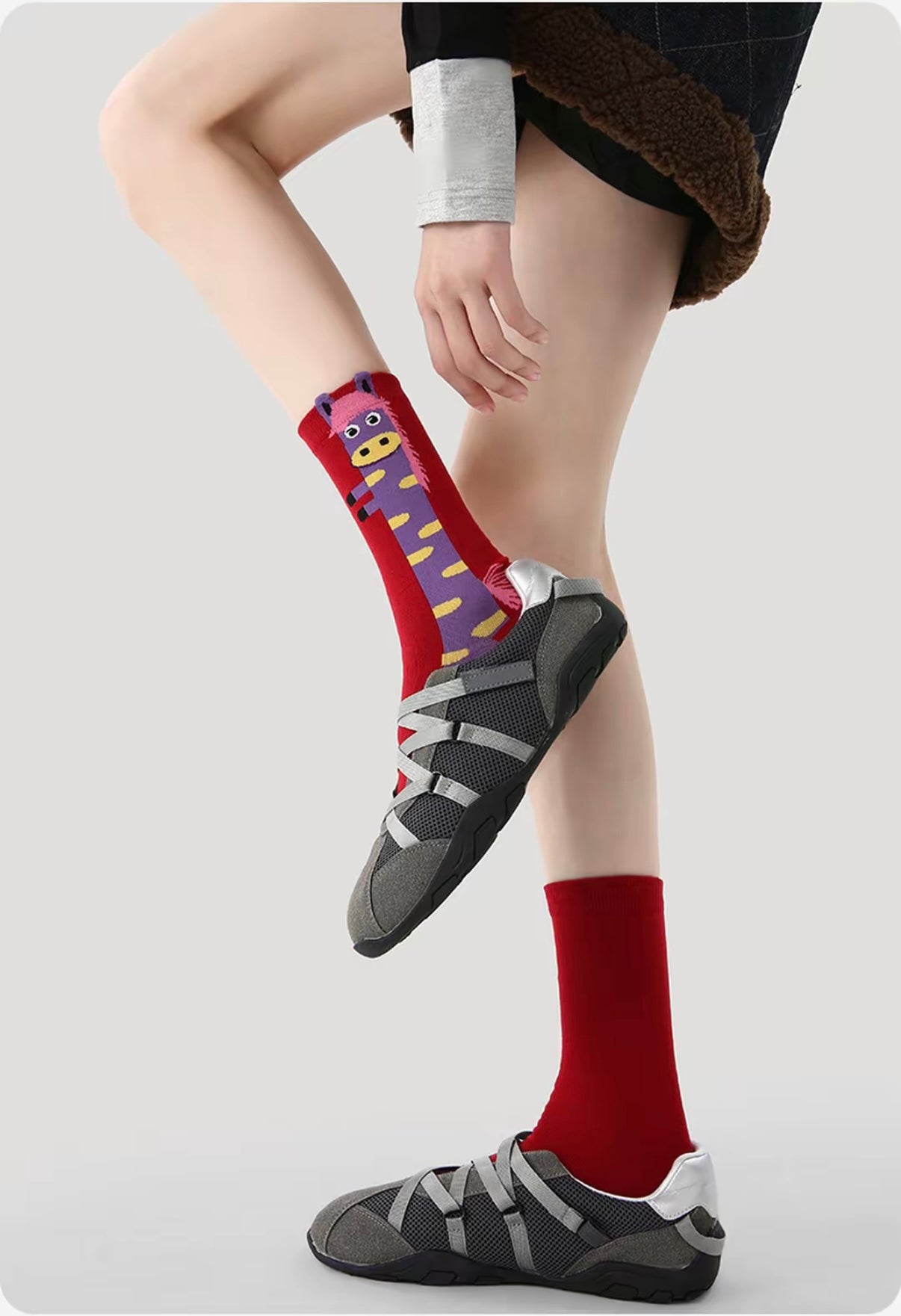 Year of Horse socks pack featuring three red socks with playful horse designs in purple, green, and pink